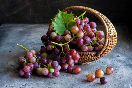 Grapes in the basket on vintage backgroundの写真素材