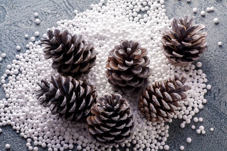 Pine cones with snow on vintage blue background. Happy new year card.の写真素材