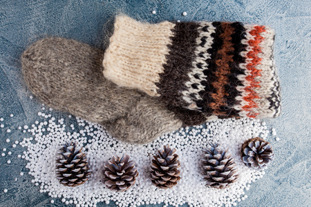 Handmade sock and cones with snow on vintage background.の写真素材