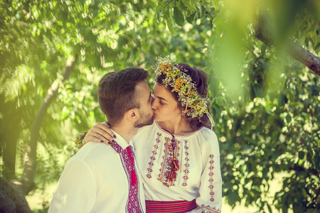 Young couple kissing in the parkの写真素材