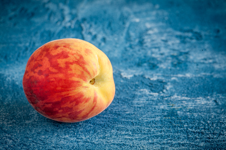 Fresh peach on blue stone backgroundの写真素材