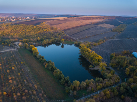 Flight over the small lake. Autumn landscapeの写真素材