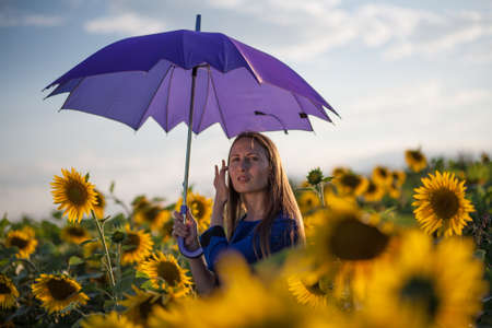 Beautiful woman with blue umbrellaの写真素材