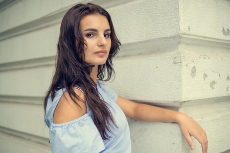 Girl and city. Fashion woman portrait of young pretty trendy brunet girl posing at the city in...