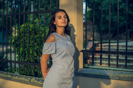 Girl and city. Fashion woman portrait of young pretty trendy brunet girl posing at the city in Europeの写真素材
