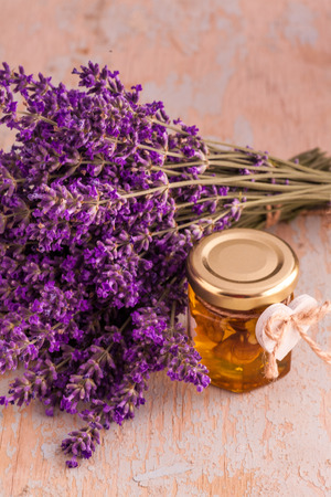 Lavander with aromatic oil on old wooden backgroundの写真素材