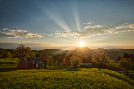 Majestic sunset in the mountains landscape. Carpatian mountains Romania in the spring.の写真素材