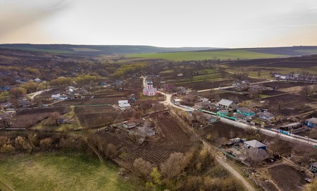 Aerial view of a little village with a church in the center at sunset. European village.の写真素材