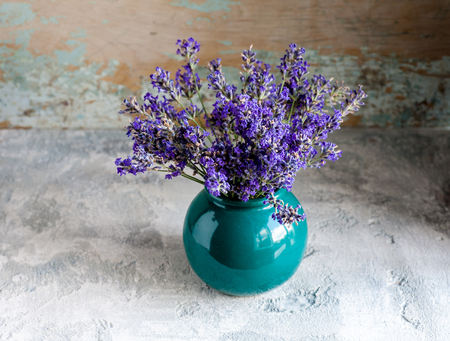 Lavander bouquet in vase on gray stone backgroundの写真素材