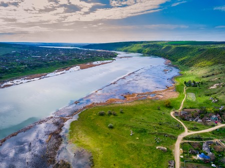 Arial view over the river and small village.の写真素材