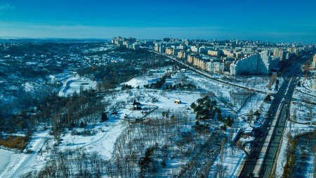 Top view of city in winter at sunset on sky background. Aerial drone photography concept. Kishinev,...