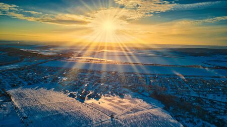 Top view of city suburbs or small town nice houses on winter sunset on cloudy sky background.の写真素材