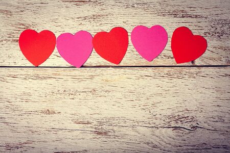 Colored paper hearts on a wooden background. Holidays. Valentine's Day.の写真素材