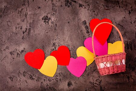 Colored paper hearts on a grey stone background. Holidays. Valentine's Day. Text spase.の写真素材
