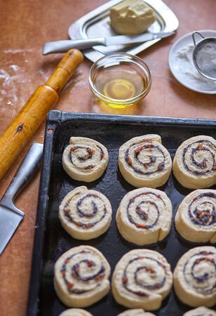 Homemade sweet traditional dessert, pastry snails on baking trayの写真素材