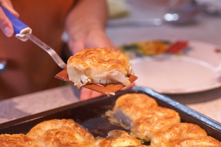 Woman taking delicious homemade pies from table, top view