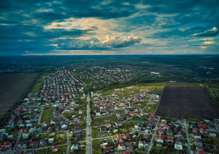 Aerial view from drone. Aerial view amazing sunset over of the suburbs with the city, far villages and fieldsの写真素材