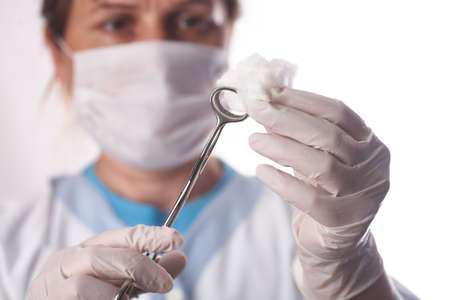theater assistant preparing swab for surgeonの写真素材