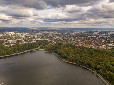 Aerial view of a lake in a park with autumn trees. Kishinev, Moldova. Epic aerial flight over water....