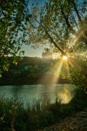 Bright Sun Beams Shining Through Trees. Magestic autumn sunset.の写真素材