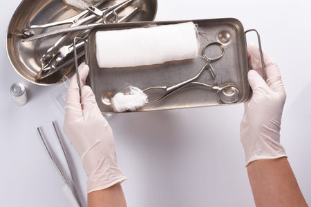 Dental appliances in sterile packaging. Dentists hand in glovesの写真素材