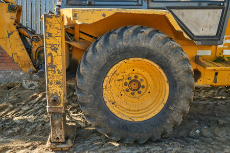 Excavator loader machine during earthmoving works outdoorsの写真素材