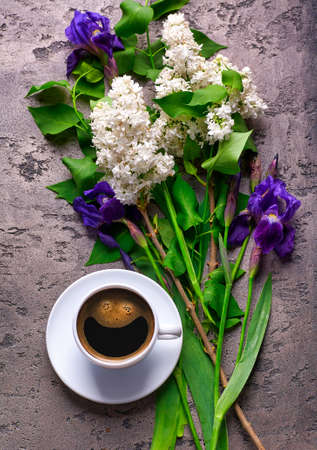 Coffee and lilac flowers on gray concrete backgroundの写真素材