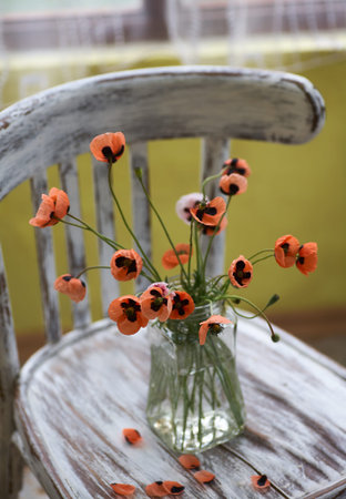 A Little Red Poppies Bouquet Arranged In Classical Style Stillife of popies in a glasses vase on vintage sherの写真素材