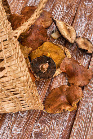 Basket full with big mushrooms on wooden table outdoorの写真素材
