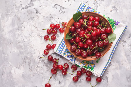 A bowl of red cherry on grayの写真素材