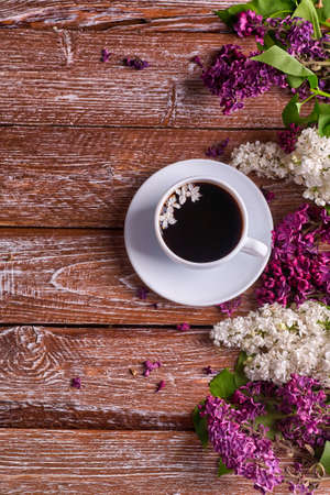 Coffee Cup And Colorful Lilac Flowers On Garden wooden Tableの写真素材