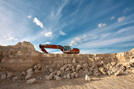 Excavator stands on the background of a stone quarry.