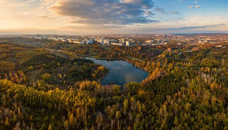 Aerial view of a lake in a park with autumn trees. Kishinev, Moldova. Epic aerial flight over water. Colorful autumn trees in the daytime.の写真素材