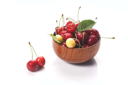 Cherry In wooden Bowl Isolated On White Backgroundの写真素材