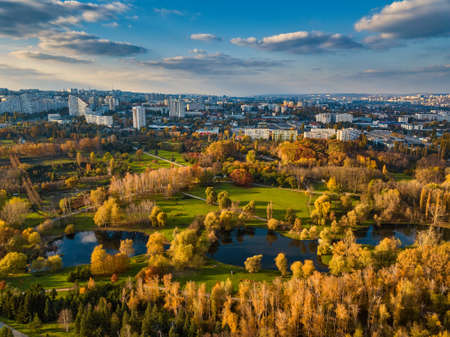 Aerial view of a lake in a park with autumn trees. Kishinev, Moldova. Epic aerial flight over water. Colorful autumn trees in the daytime.の写真素材