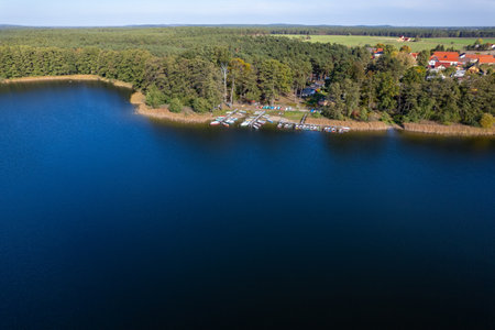 Aerial shot of beautiful lake surrounded by forest in a calm autumn day. Germany.の写真素材