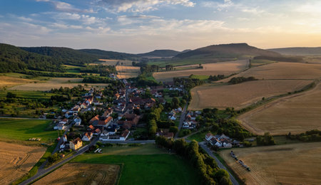 Aerial view of a German village surrounded by meadows, farmland and forest. Germany.