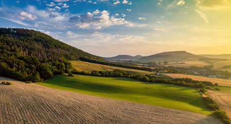 Aerial view of a German village surrounded by meadows, farmland and forest. Germany.