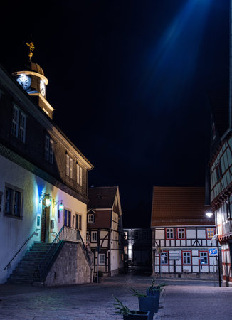 Bleicherode, Germany - 08/17/2023: Street alley in the small town of Schwabisch Hall, with houses and buildings with typical German architecture and street lanterns, at night.のeditorial素材