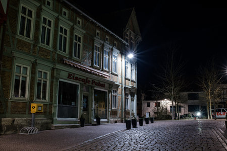 Bleicherode, Germany - October 08, 2023: Street alley in the small town of Schwabisch Hall, with houses and buildings with typical German architecture and street lanterns, at night.のeditorial素材