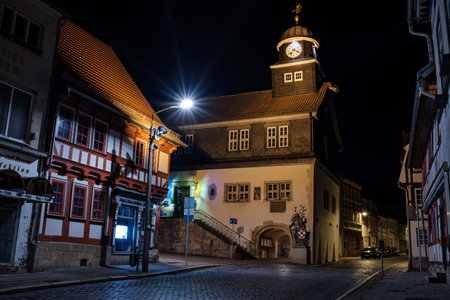 Bleicherode, Germany - October 08, 2023: Street alley in the small town of Schwabisch Hall, with houses and buildings with typical German architecture and street lanterns, at night.のeditorial素材