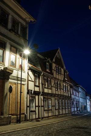 Bleicherode, Germany - October 08, 2023: Street alley in the small town of Schwabisch Hall, with houses and buildings with typical German architecture and street lanterns, at night.のeditorial素材