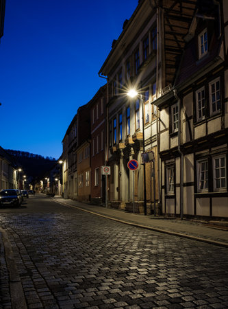 Bleicherode, Germany - October 08, 2023: Street alley in the small town of Schwabisch Hall, with houses and buildings with typical German architecture and street lanterns, at night.のeditorial素材