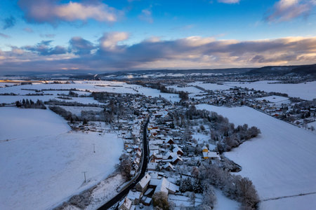 Aerial view of a small German mountain village covered by heavy snow at sunset. Germany.の写真素材