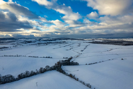 Aerial view of a small mountain village covered by heavy snow at sunset.の写真素材