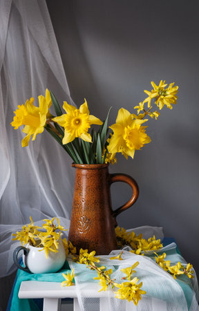 A stunning arrangement of vibrant yellow flowers in a vintage pitcher, showing natures captivating beauty. Yellow daffodilsの写真素材