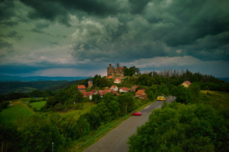 A stunning aerial capture of a historic castle nestled elegantly amidst lush green fields and picturesque scenery. Hanstein castle, Germany.の写真素材