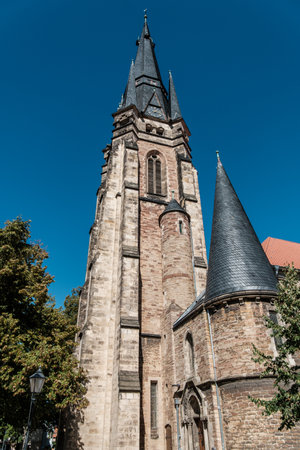 A breathtakingly stunning view showcasing a Gothic church tower set against a bright blue sky above. Germany.の写真素材