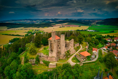 A stunning aerial capture of a historic castle nestled elegantly amidst lush green fields and picturesque scenery. Hanstein castle, Germany.の写真素材