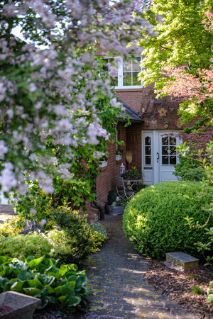 A beautiful and vibrant garden scene that features a variety of blooming flowers and finely manicured hedgesの写真素材